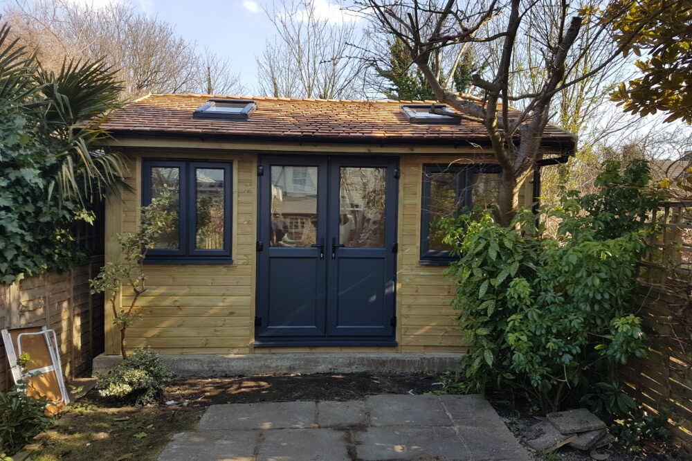 Insulated Garden Room with cedar shingles and velux windows