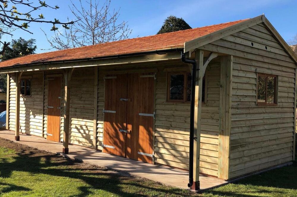 Cart lodge garage with cedar shingles and lined canopy