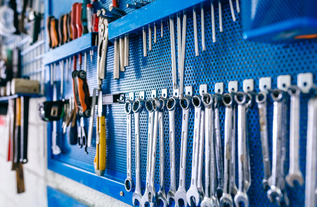 Detail of motorcycle workshop tools board with wrenches in the foreground