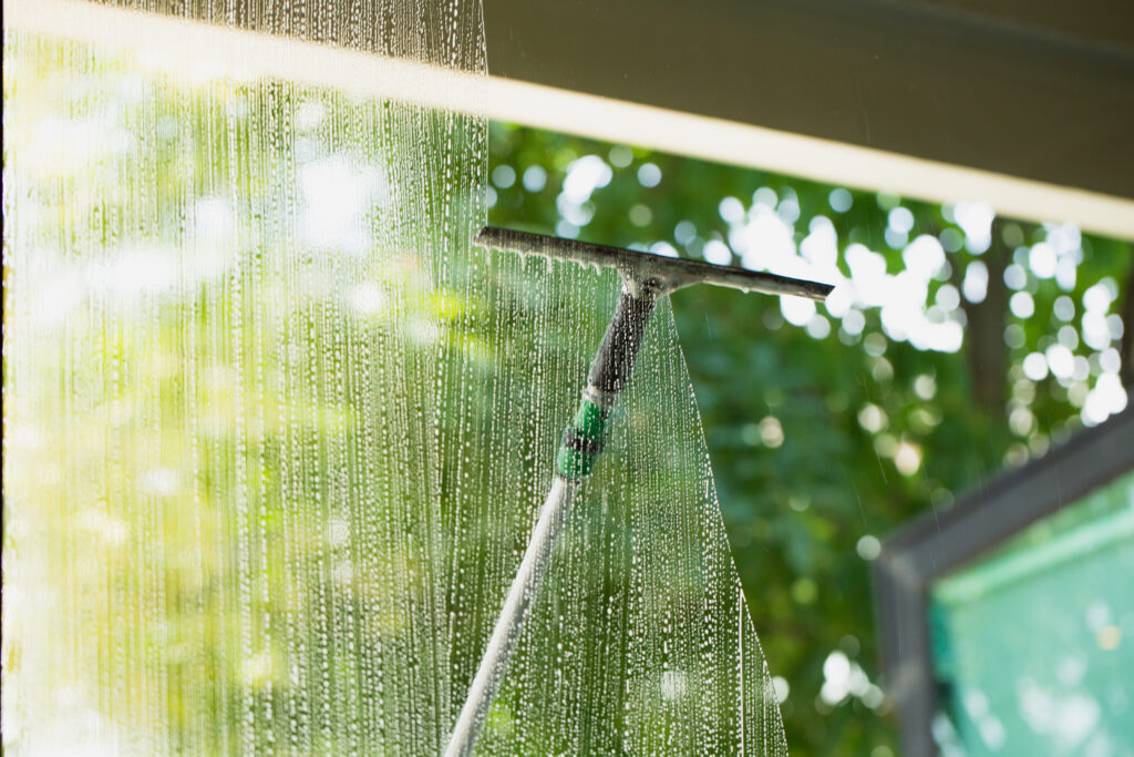 Cleaning window pane with glass cleaner. Cleaning glass concept