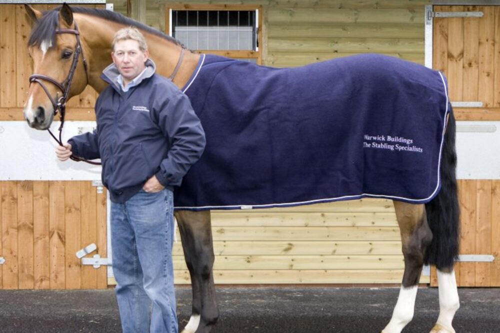 Man standing with brown horse