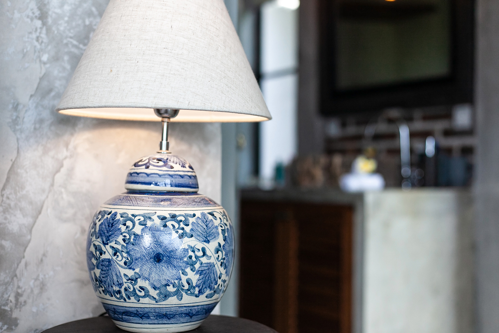 A Large Ceramic Lamp With Blue Patterns On A White Background