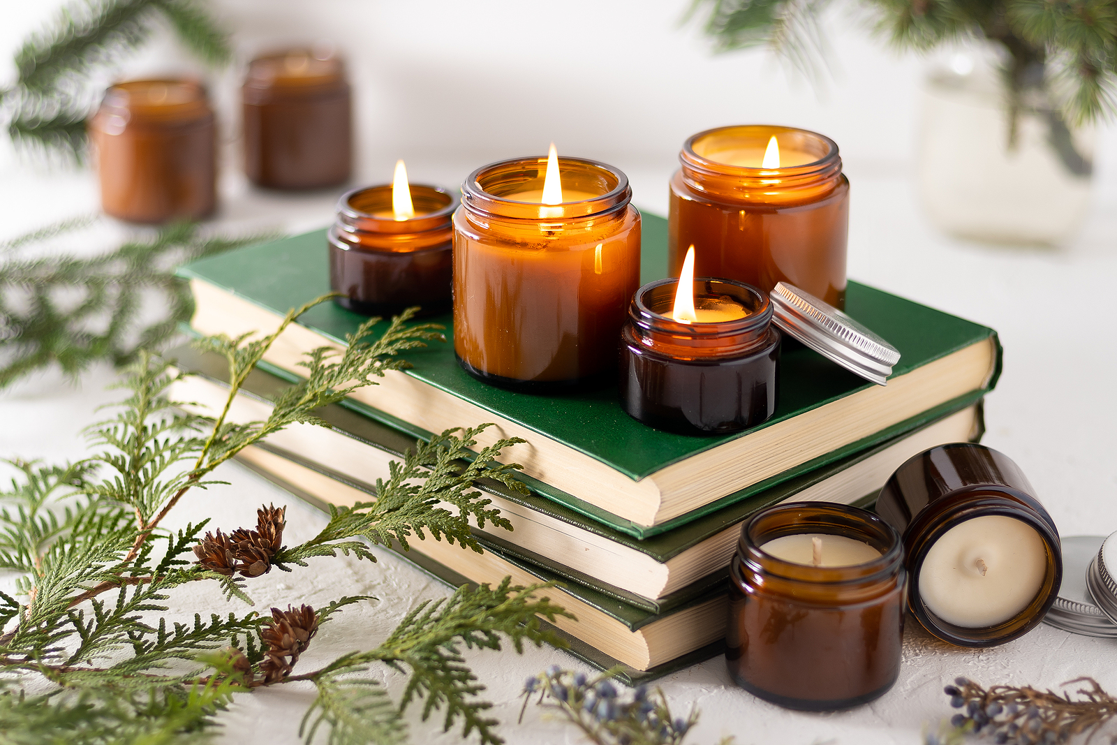 A Set Of Different Aroma Candles In Brown Glass Jars. 