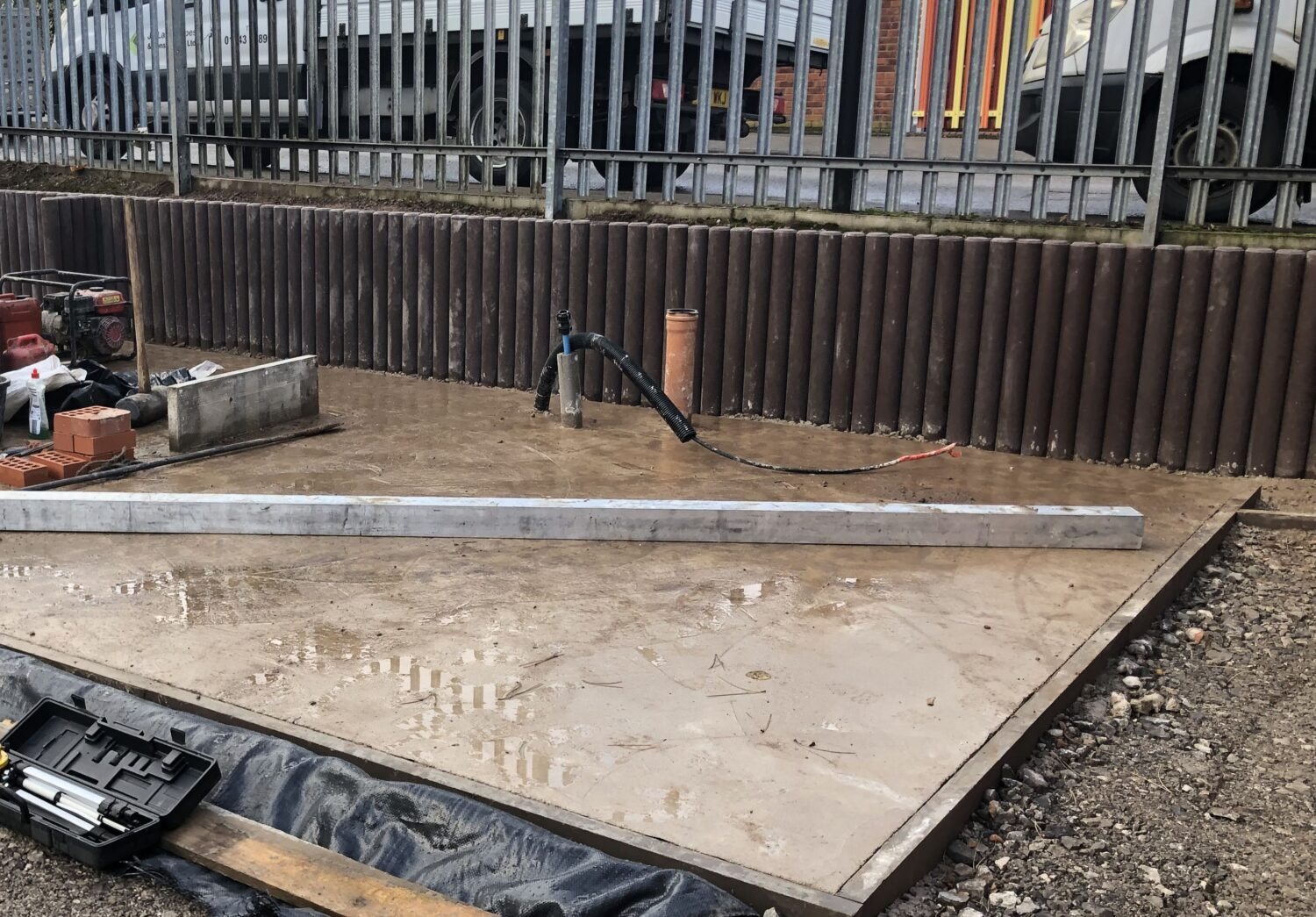 concrete pad with service pipes for garden office