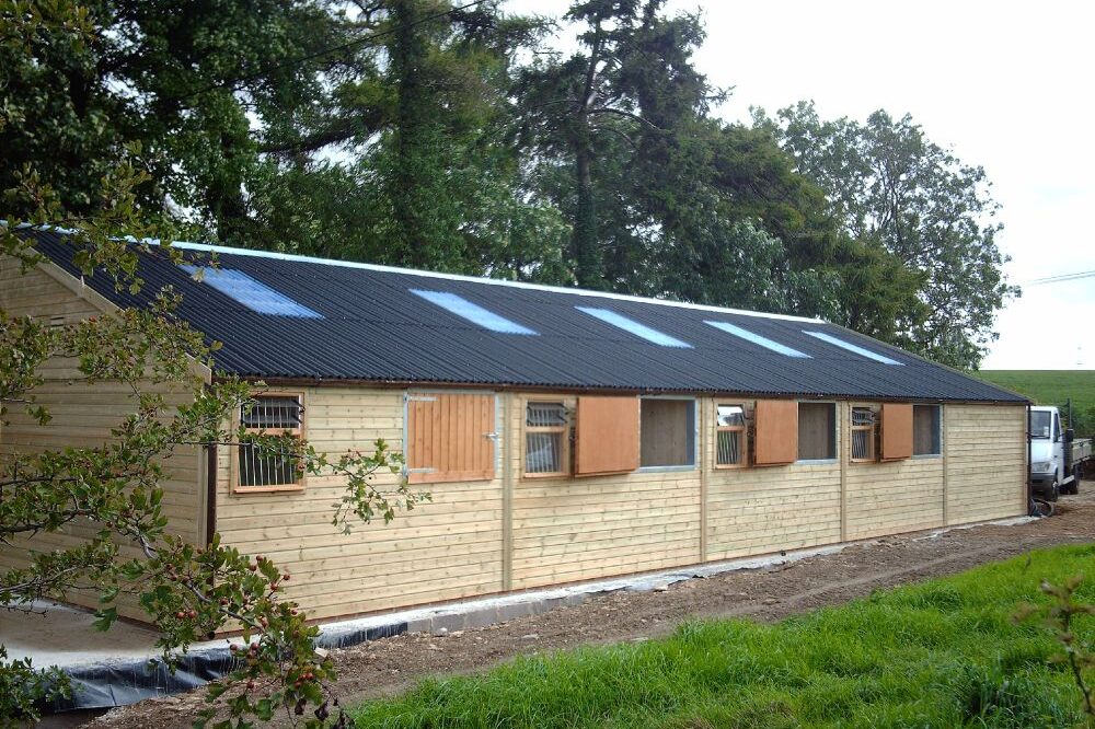 Wooden horse stables with doors open