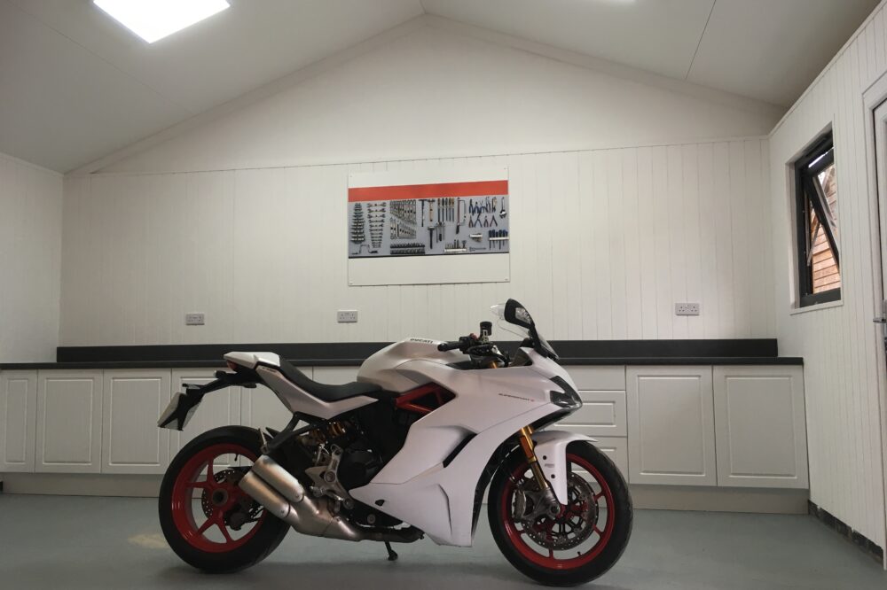 Inside garage with white motorcycle