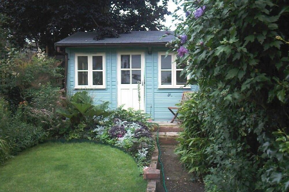 blue painted wooden garden studio building