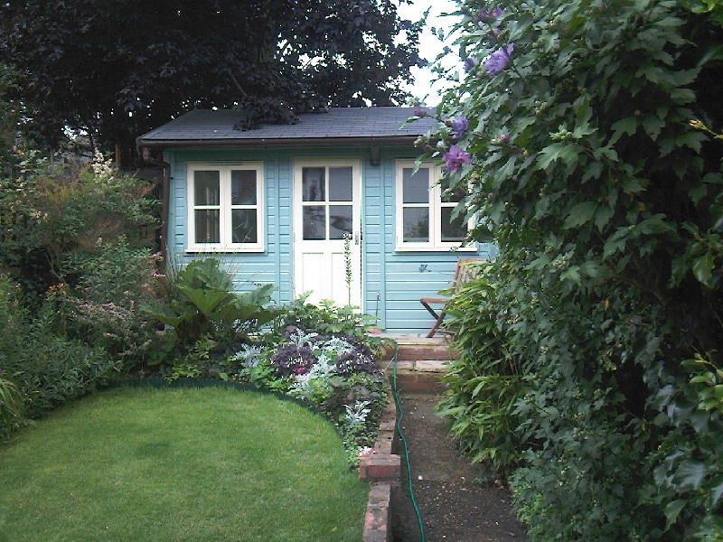 blue painted wooden garden studio building