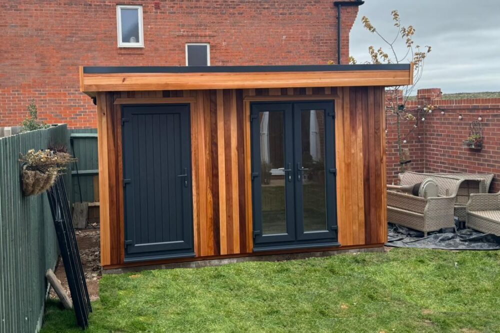 Modern timber shoffice with shed storage door and office French doors in a residential garden
