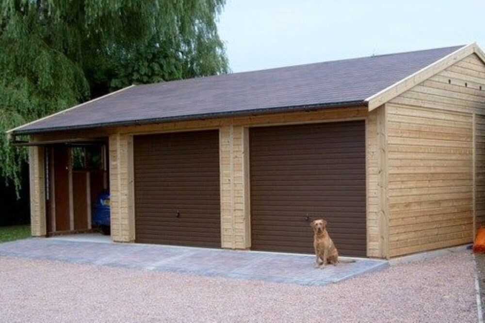 triple garage with dog sat in front